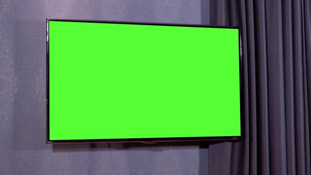 Closeup on a green screen on a wall
