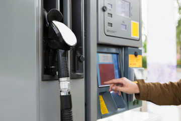Self-service filling station. The man chooses the amount on the touch screen