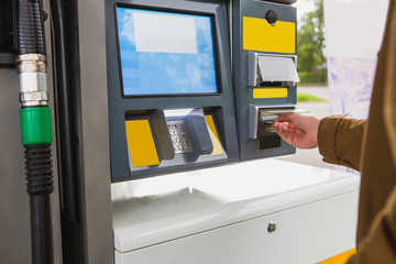 Self-service filling station. A man pays for fuel with a credit card