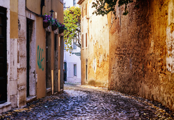 Lisbon, the capital of Portugal, narrow street in the historic old town center, image with retro toning