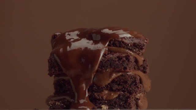 chocolate cake with chocolte cream with different texture. with liquid chocolate pouring on it
