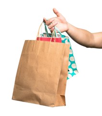 Hand holding Shopping bag over isolated white background