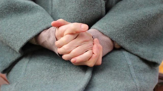 Close up of senior elderly woman suffering from hands diseas, woman rubs hands 