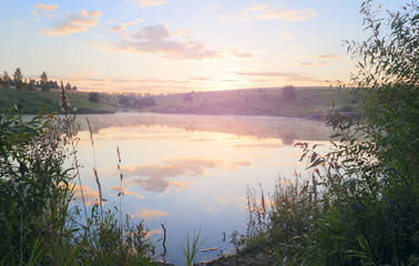 Summer landscape with river.Sunny quiet morning.Fog on the water.River Krasivaya in Tula region,Russia. 