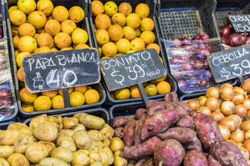 Market stall with tropical fruits and vegetables.