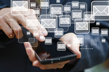 Businessman pushing on cellphone check mail message