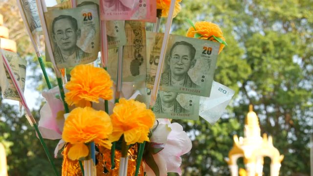 Thai money baht. Banknotes in nominal value of 20 baht. Paper money on Buddha statue background