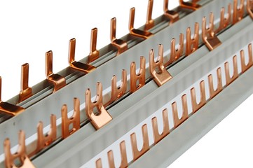Detail of various connecting wiring bars with brass connectors of various shapes, plastic base, white beckground.