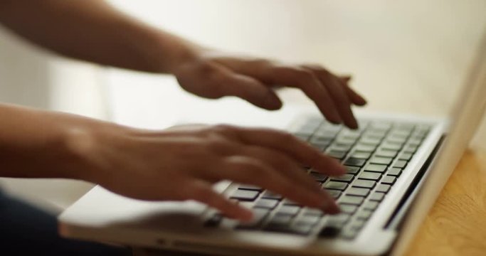 4k, Close-up of hands typing on a laptop keyboard.