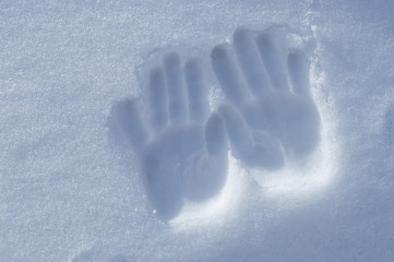 children's hands in the snow.