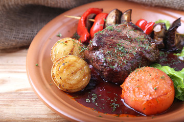 Juicy beef steak with  roast vegetables  in a plate