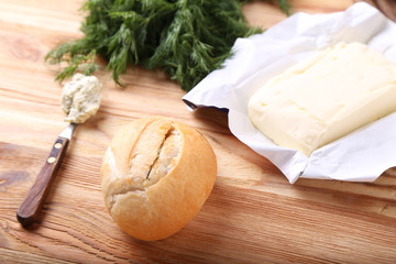 Fototapeta na wymiar Fresh bun with butter, garlic and greens