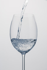 pour mineral water into wine glass