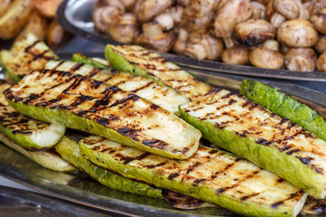 Freshly cooked vegetables on the grill, outdoors. Background of vegetables on the grill.