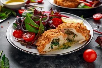 Peel and stick wall murals Kiev Breaded Chicken Kiev breast stuffed with butter, garlic and herbs served with vegetables in a plate.