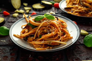 Vegetarian Italian Pasta Spaghetti alla Norma with eggplant, tomatoes, basil and parmesan cheese. - obrazy, fototapety, plakaty