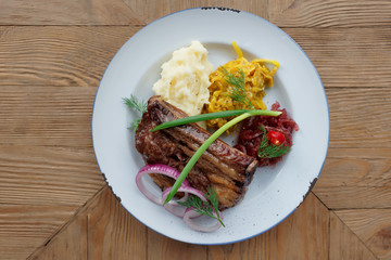 Grilled pork ribs with sauerkraut and mash potatoes