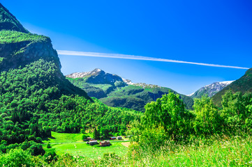 View on spring landscape and red wooden buildings in Norway
