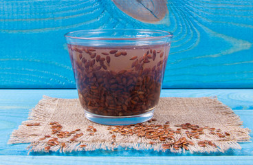 Raw and boiled linseed, organic food for healthy eating.