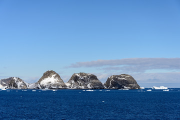 Rocks with snow in sea