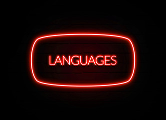 Languages neon sign on brick wall background.