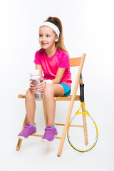 Cute little girl with tennis racket on white background