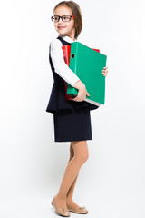 Little girl with binders in her hands dressed as a businesswoman
