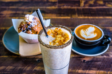 A bright cafe breakfast setting featuring a banana smoothie
