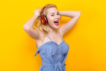 Blonde girl in blue striped blouse with headphones