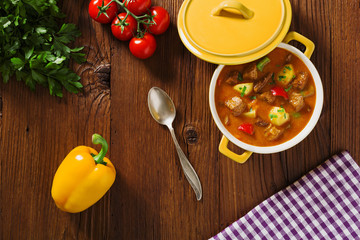 Beef stew served with cooked potatoes.