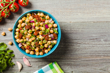 Chickpeas salad with onion and dried tomatoes. - obrazy, fototapety, plakaty