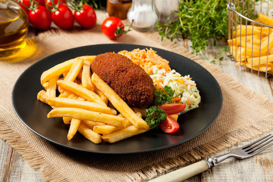 Chicken Kiev (de Volaille chop) with french fries and salads.