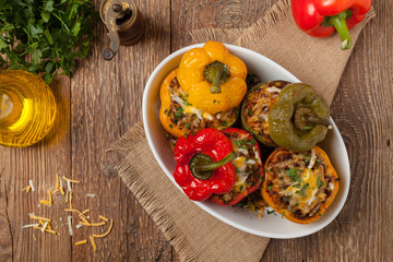 Colorful baked with cheese, stuffed peppers with rice and minced meat.