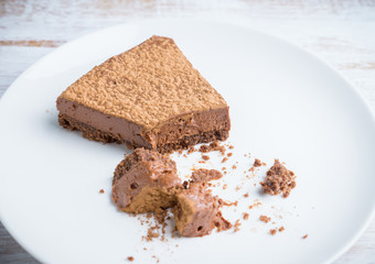 Tasty chocolate cheesecake on the rustic background. Selective focus.