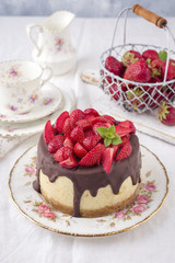 Traditional chocolate strawberry cheesecake with fresh strawberries as top view on a plate