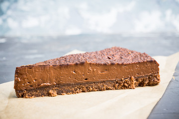 Tasty chocolate cheesecake on the rustic background. Selective focus.