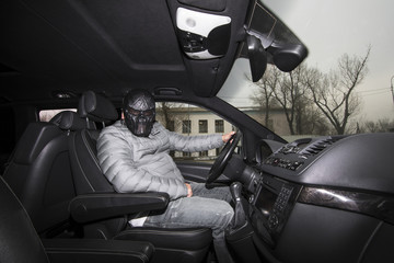 the criminal in the mask in the car