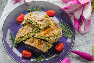 Spinach pie with cherry tomatoes prepared in the traditional way