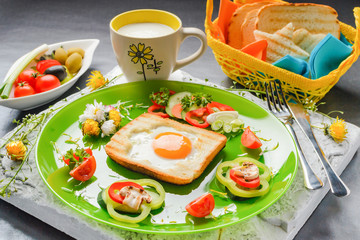 Egg in toast bread baked in the shape of a flower with fresh vegetables and yogurt