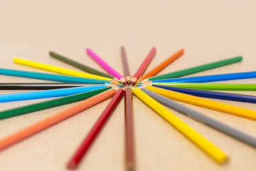 Naklejka premium Ring of pencils isolated on a light background. Multicolored pencils