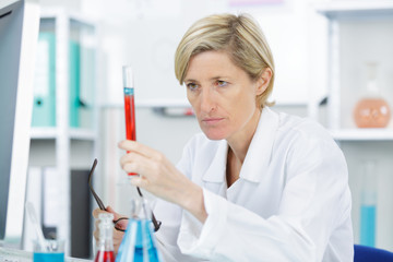 closeup of beautiful lab worker holding up test tube