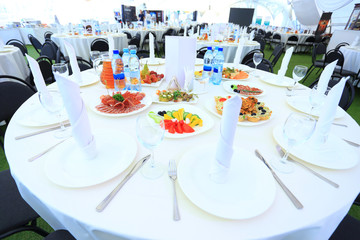 catering table set service with silverware and glass