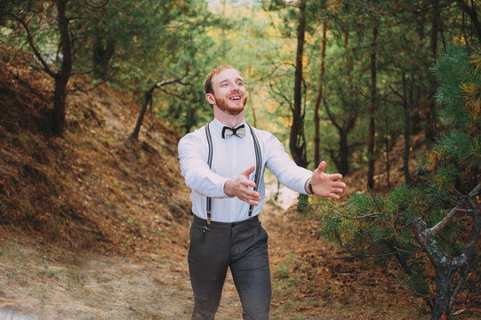 Hipster. Stylish groom with beard posing outdoors