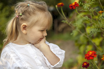 Beautiful white young girl looking with surprise at the live flowers