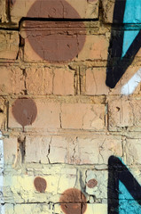 The old wall, painted in color graffiti drawing red aerosol paints. Background image on the theme of drawing graffiti and street art