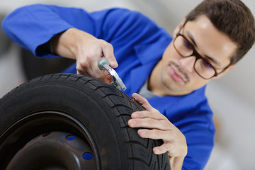 mechanic inspecting a wheel
