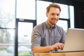 Happy cheerful man working as a freelancer