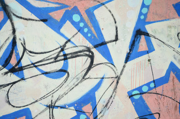 The old wall, painted in color graffiti drawing blue aerosol paints. Background image on the theme...
