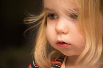 Child portrait of a girl close-up blond hair 