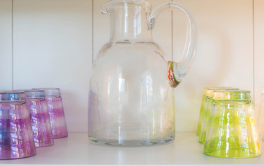 Empty Juice can with juice glasses on a shelve in a house